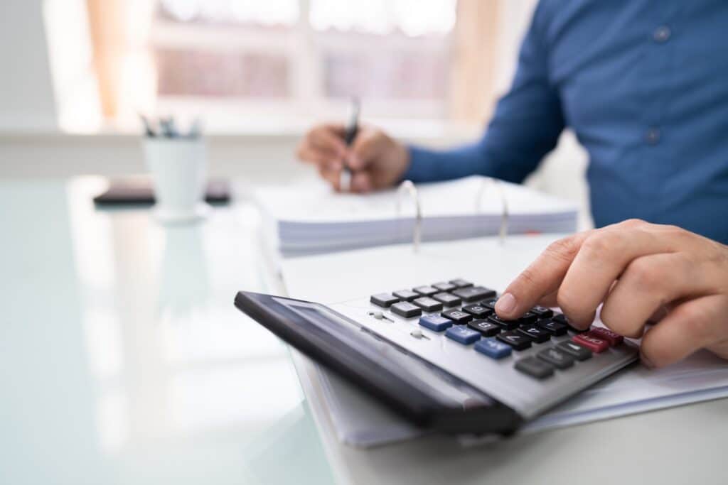 Collecting Past Due Rent Image of Man with Calculator
